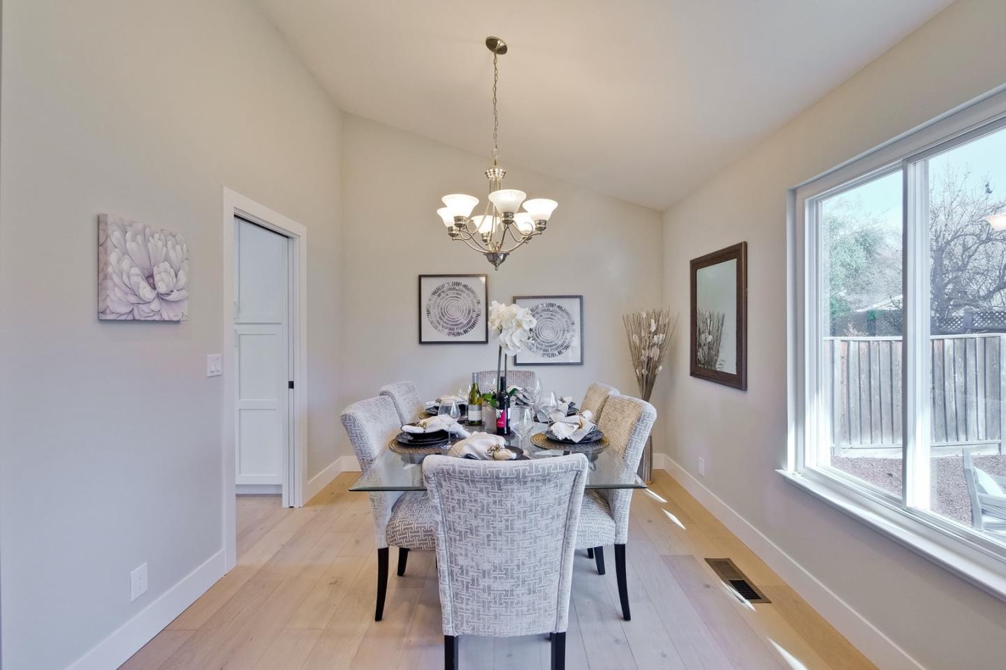 686 Thornapple Drive Sunnyvale, CA 94086 - Photo 35 of 83 a dining room with furniture a large window and a chandelier