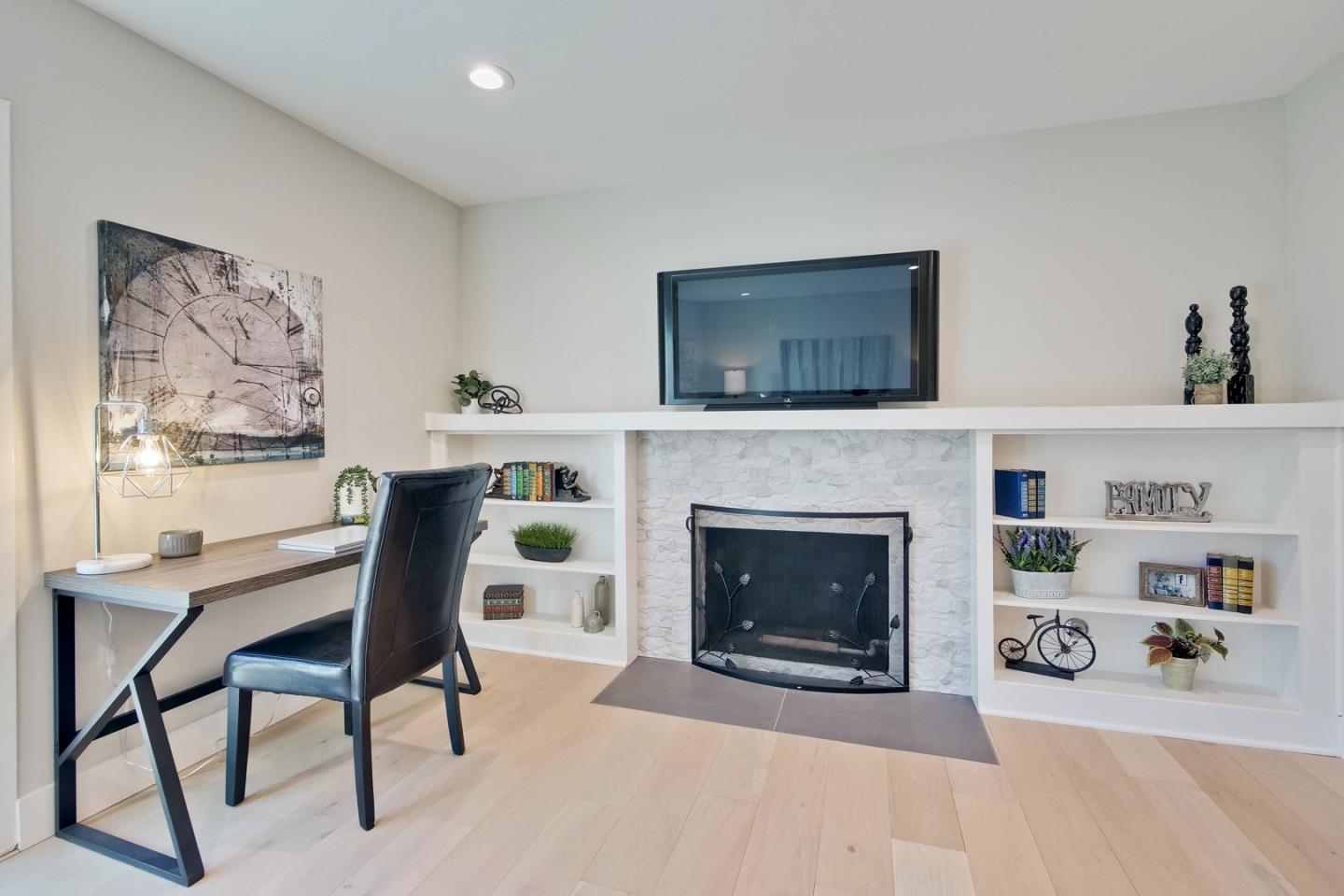 686 Thornapple Drive Sunnyvale, CA 94086 - Photo 44 of 83 a living room with furniture a fireplace and a flat screen tv