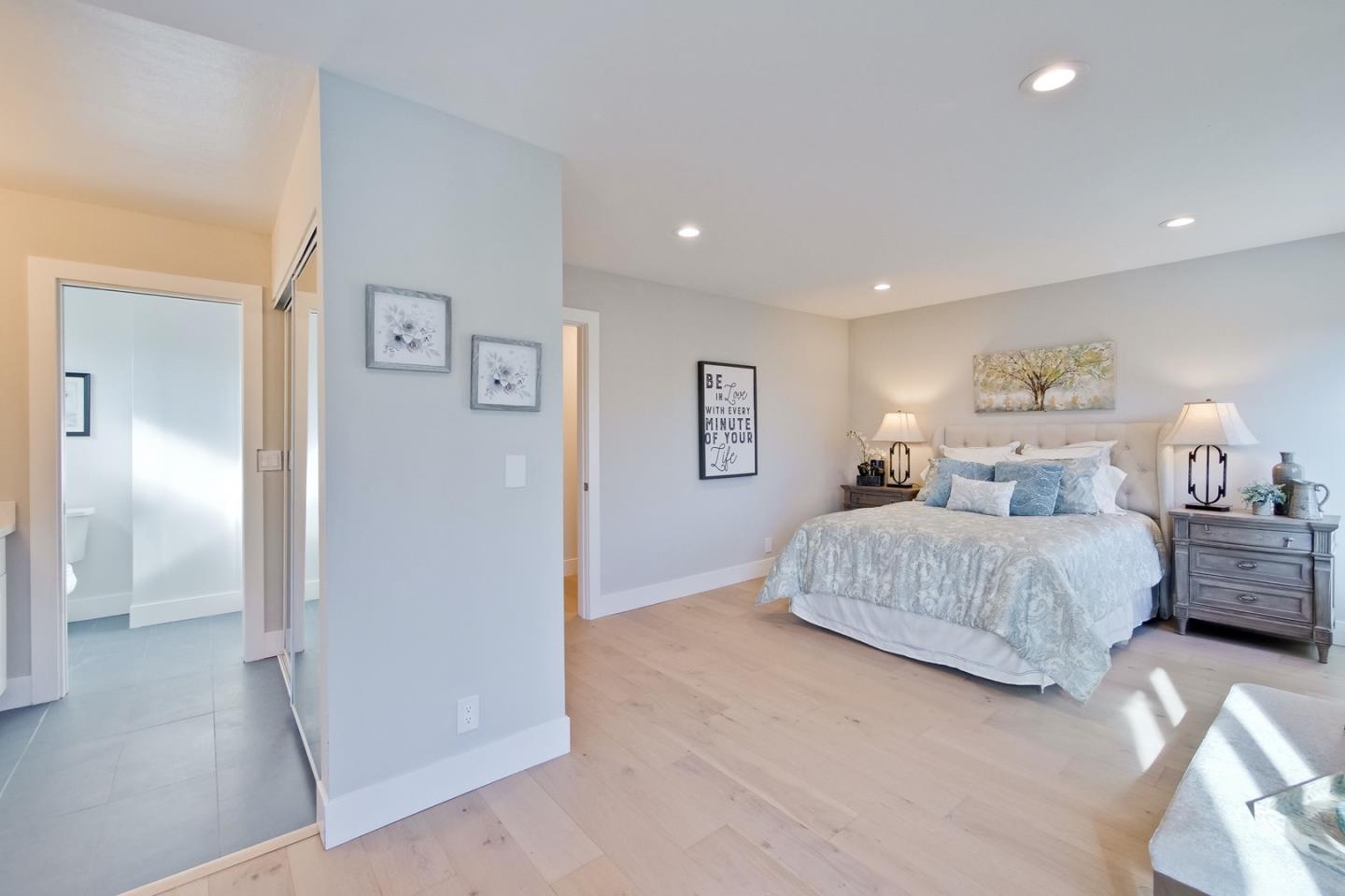 686 Thornapple Drive Sunnyvale, CA 94086 - Photo 52 of 83 a bedroom with a large bed and a chandelier