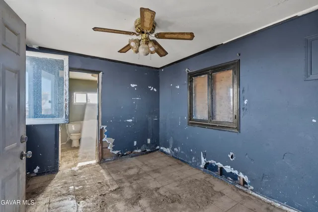 a view of a livingroom with a chandelier fan