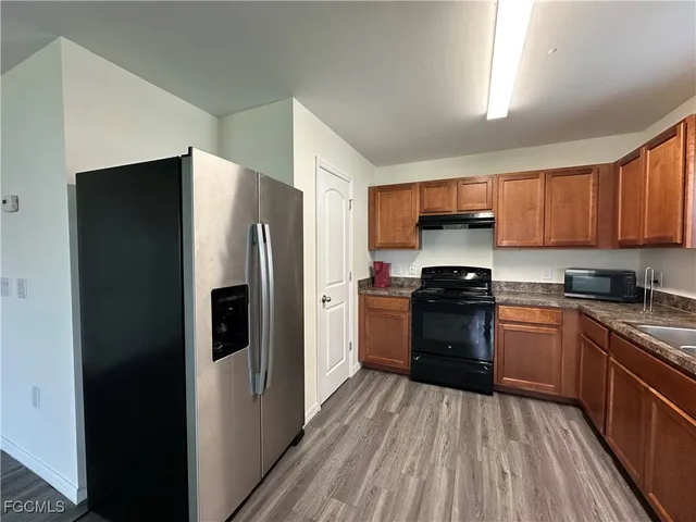 a kitchen with a refrigerator stove and sink