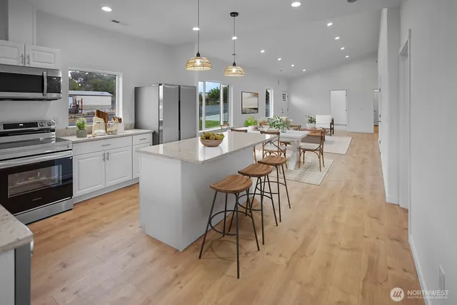 a large kitchen with a table and chairs