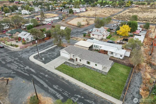 an aerial view of a house with a garden and lake view