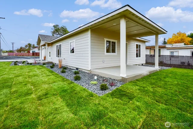 a view of a house with a yard and sitting area