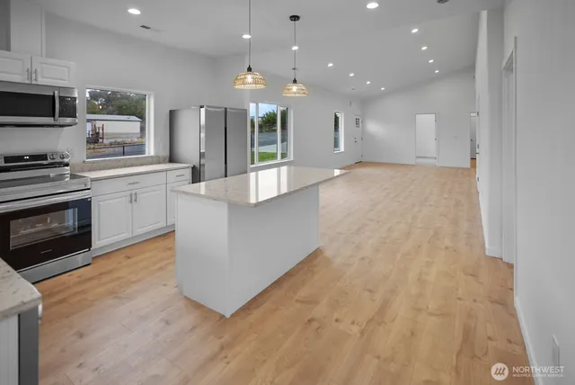 a large kitchen with cabinets and stainless steel appliances