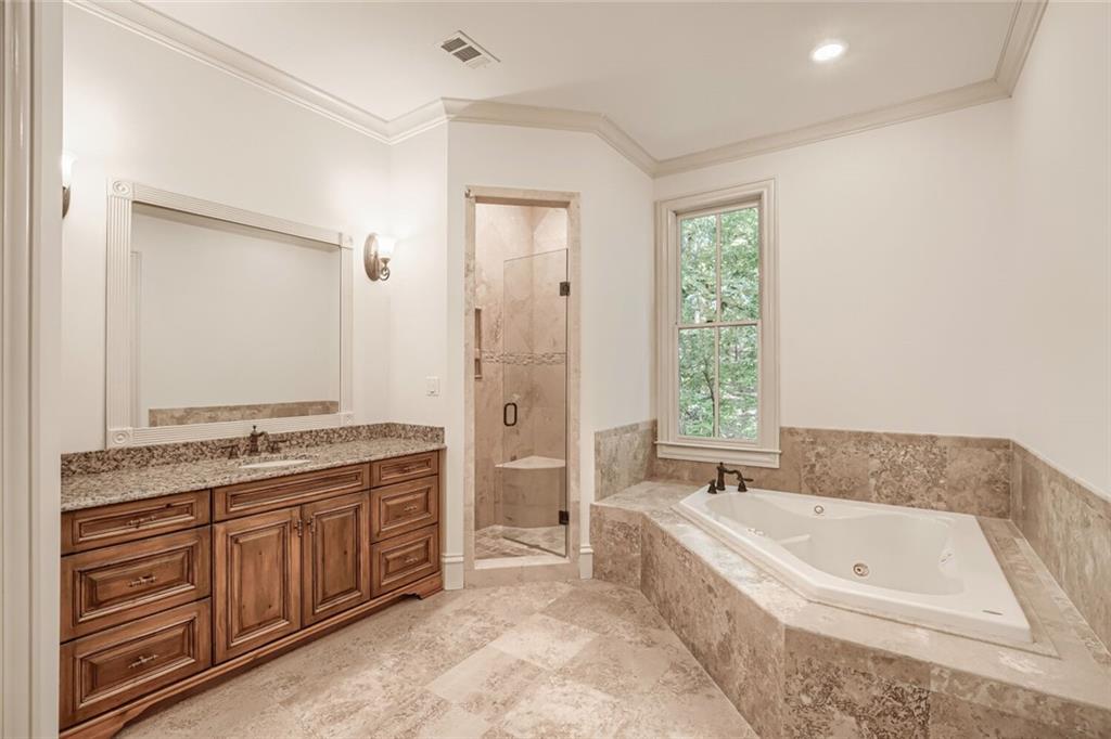 7965 Robin Road Cumming, GA 30041 - Photo 42 of 64 a spacious bathroom with a granite countertop tub sink and mirror