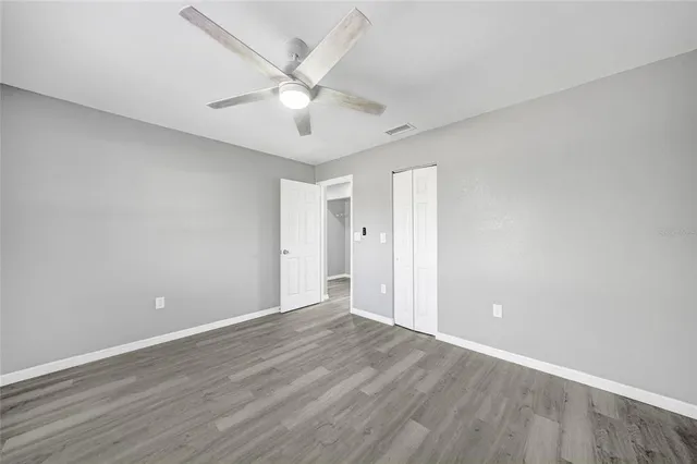 a view of an empty room with wooden floor