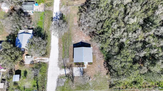 an aerial view of a house with outdoor space