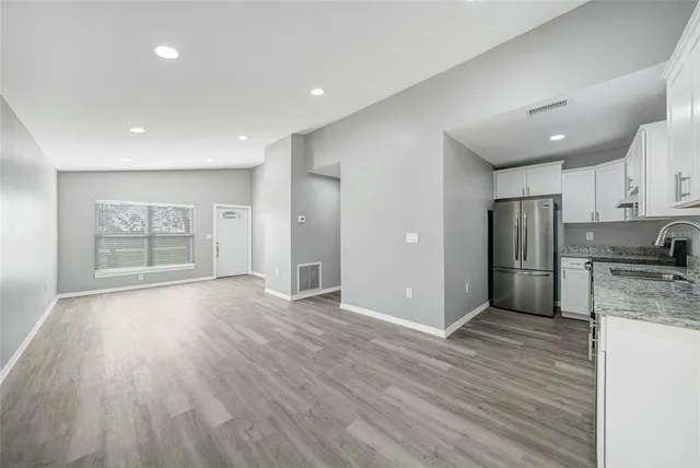 a view of a kitchen with a sink and a stove top oven