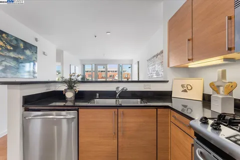 a kitchen with granite countertop a sink and cabinets