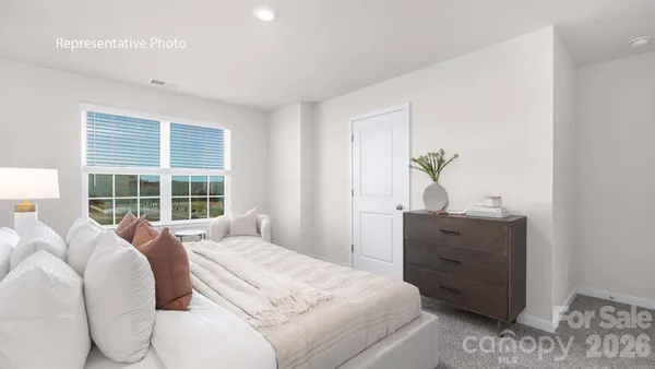 a bed room with a bed and a window