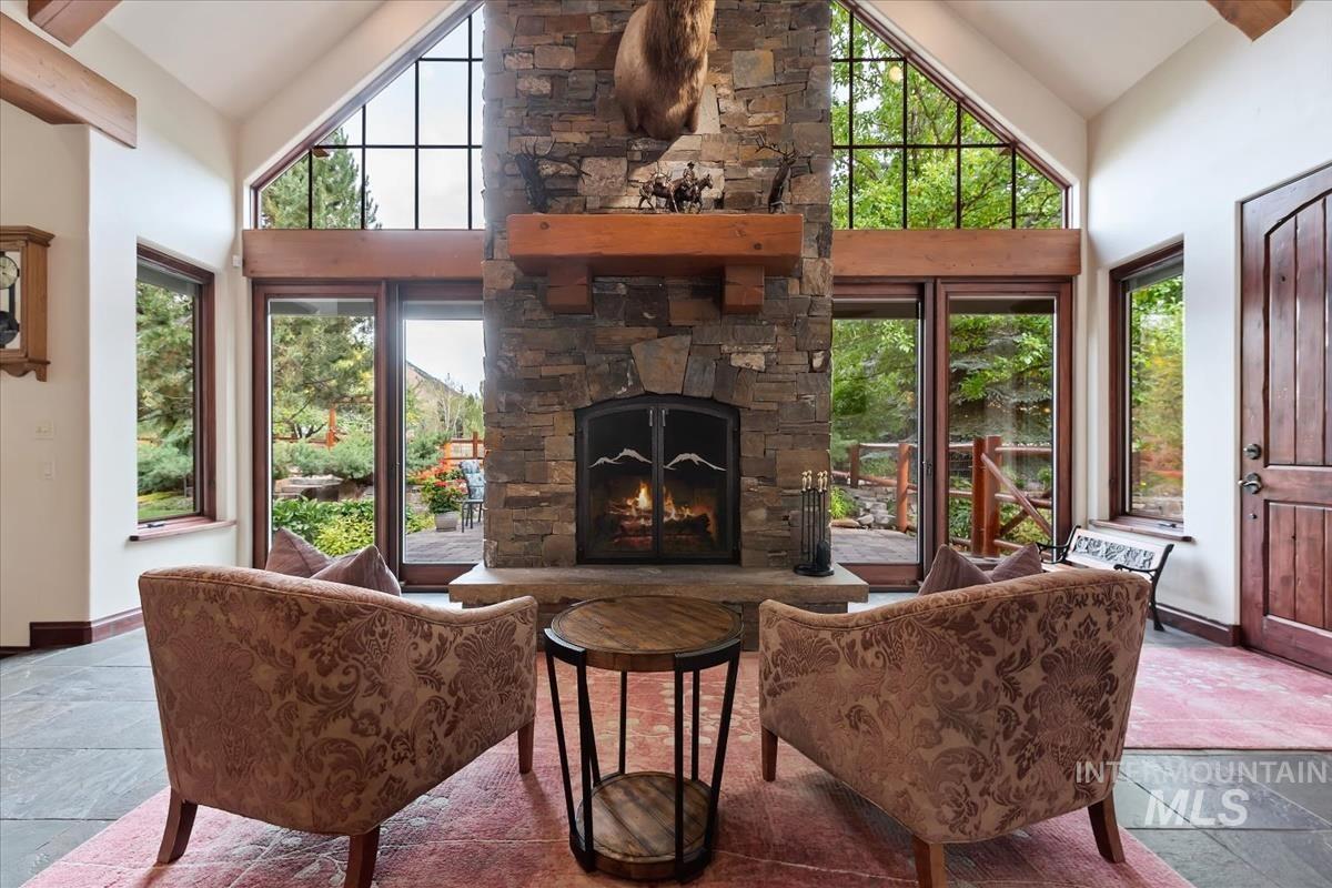106 Hidden Hollow Road Hailey, ID 83333 - Photo 23 of 49 Great room with a stone-clad fireplace, robust wood mantel, and a gas insert