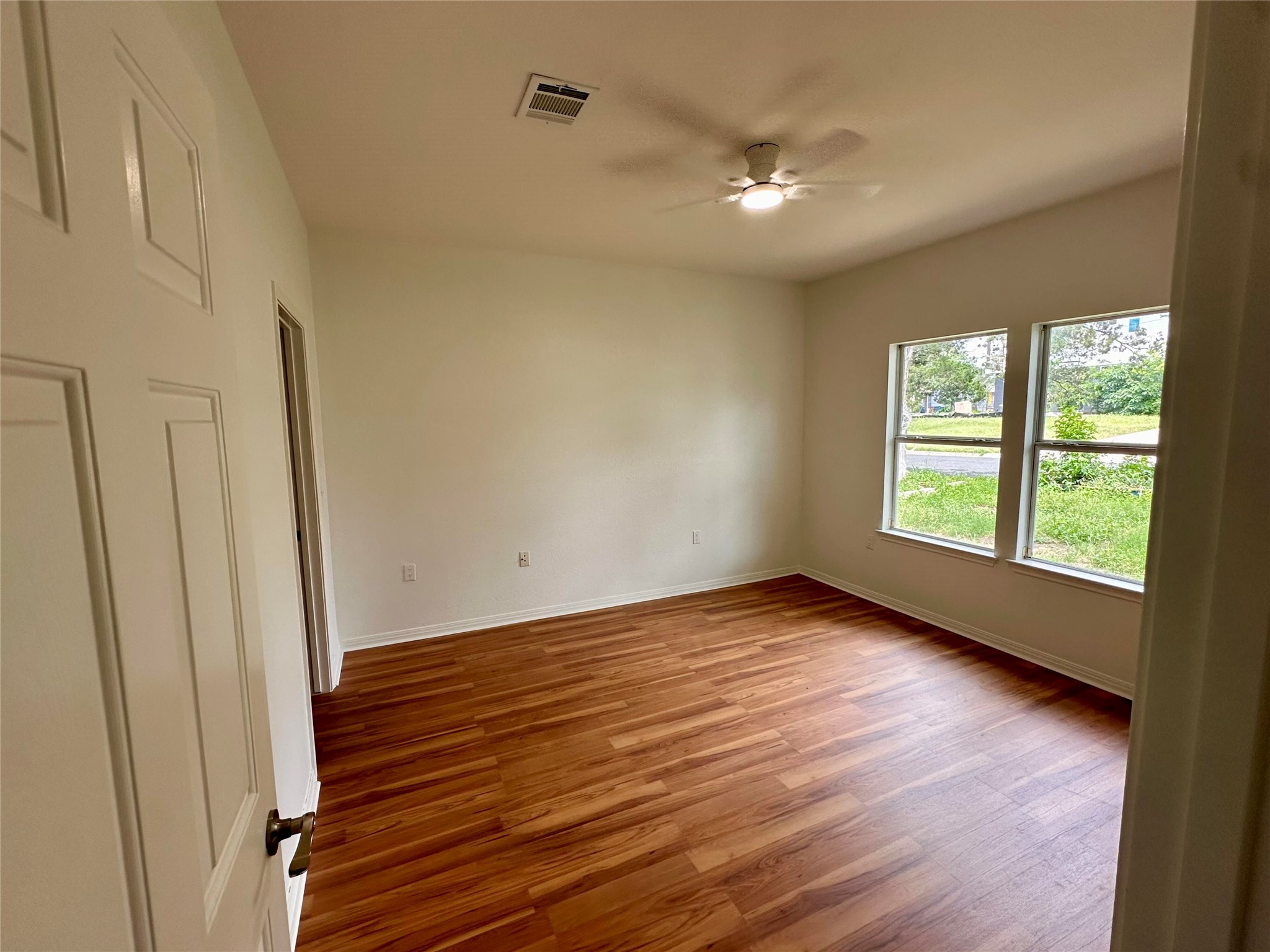 1122 Mansell Avenue Austin, TX 78721 - Photo 15 of 29 a view of an empty room with wooden floor and a window