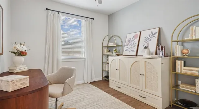 a living room with furniture a window and flowerpot