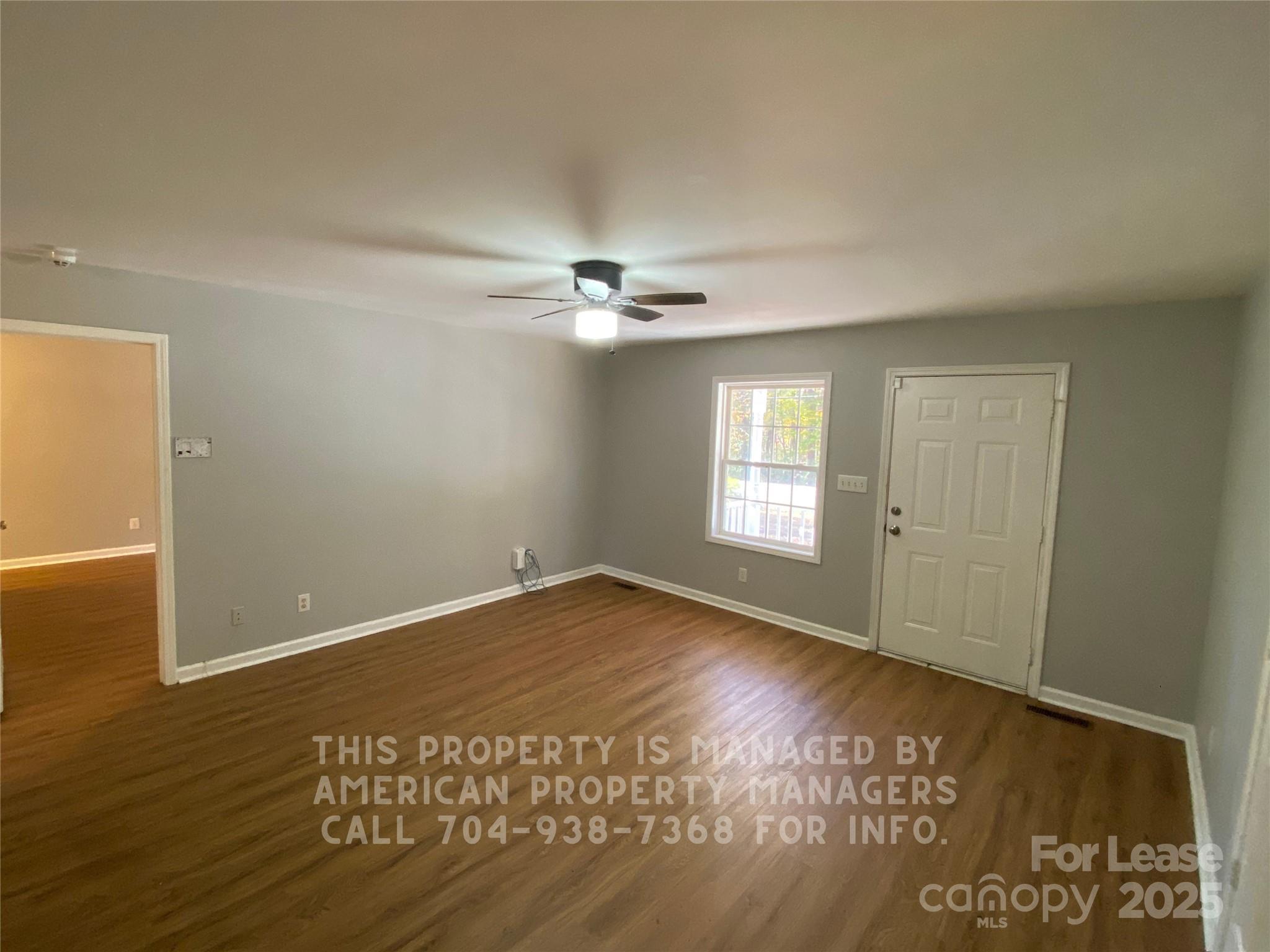 5620 Charlie Walker Road Kannapolis, NC 28081 - Photo 3 of 12 a view of an empty room with wooden floor and a window