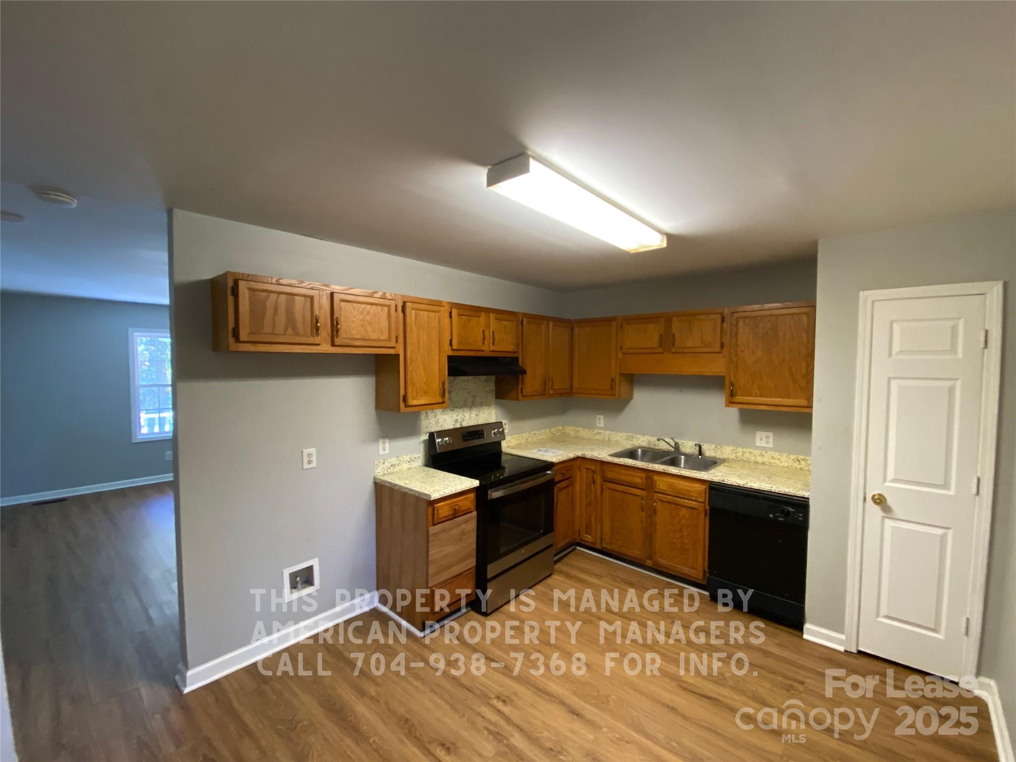 5620 Charlie Walker Road Kannapolis, NC 28081 - Photo 4 of 12 a kitchen with a sink cabinets and wooden floor