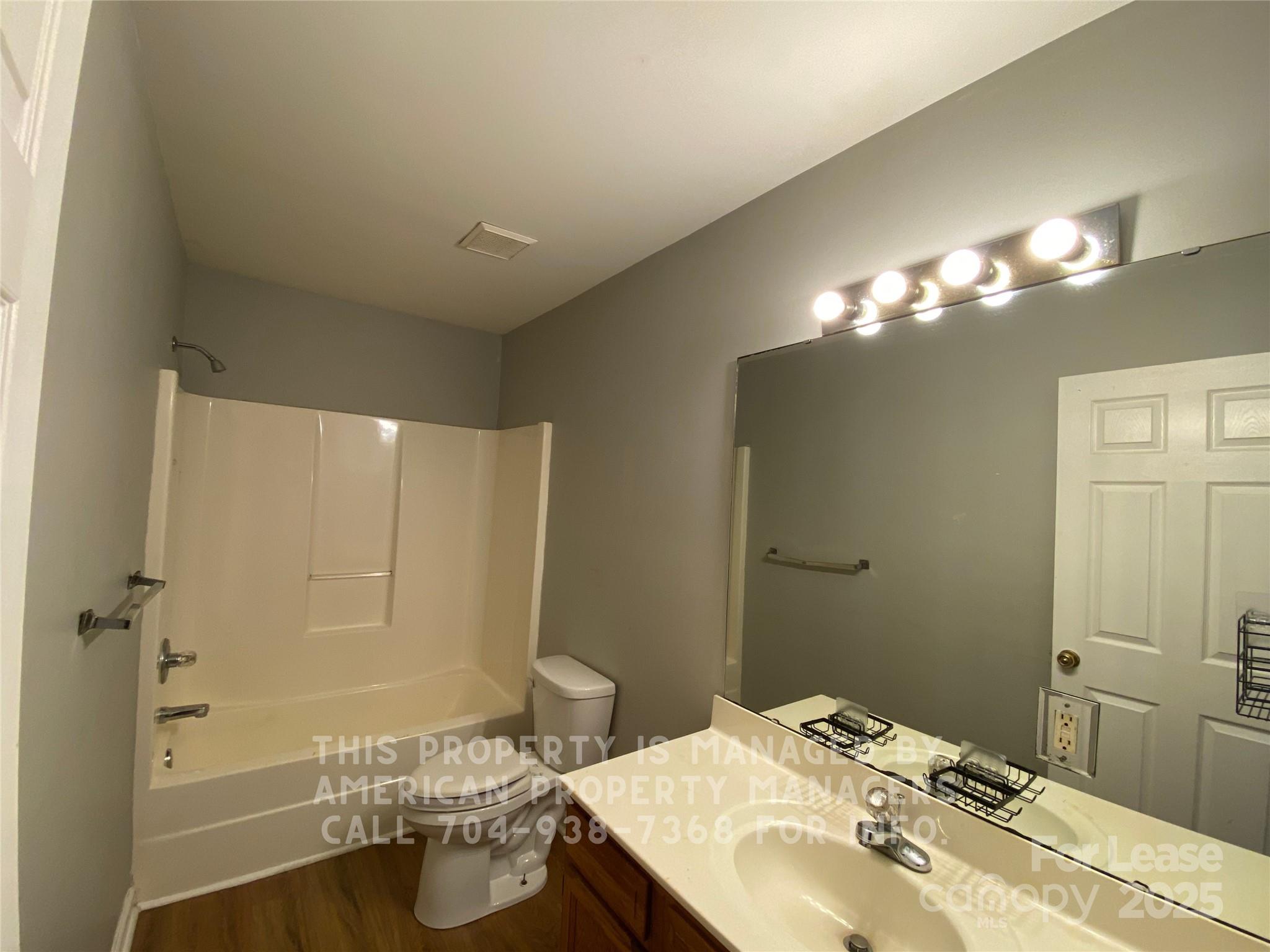 5620 Charlie Walker Road Kannapolis, NC 28081 - Photo 10 of 12 a bathroom with a sink mirror and vanity