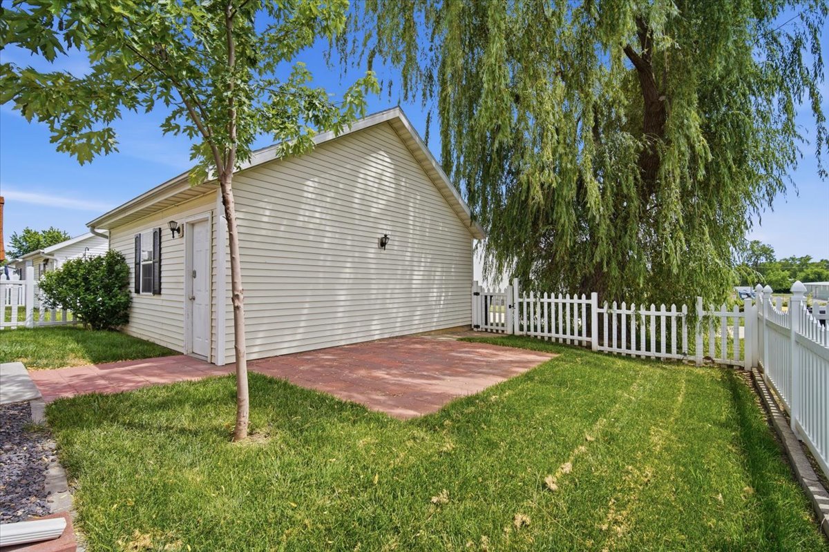 915 Teegan Street Normal, IL 61761 - Photo 32 of 33 a view of a backyard with a tree
