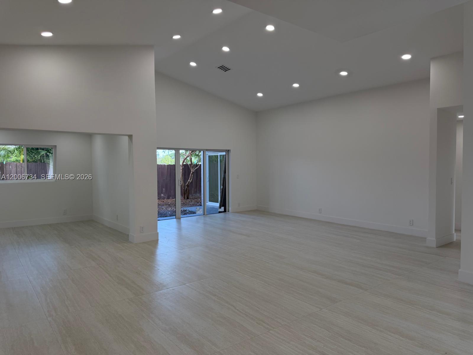 7917 Chula Vista Crescent Boca Raton, FL 33433 - Photo 14 of 28 an empty room with wooden floor and windows