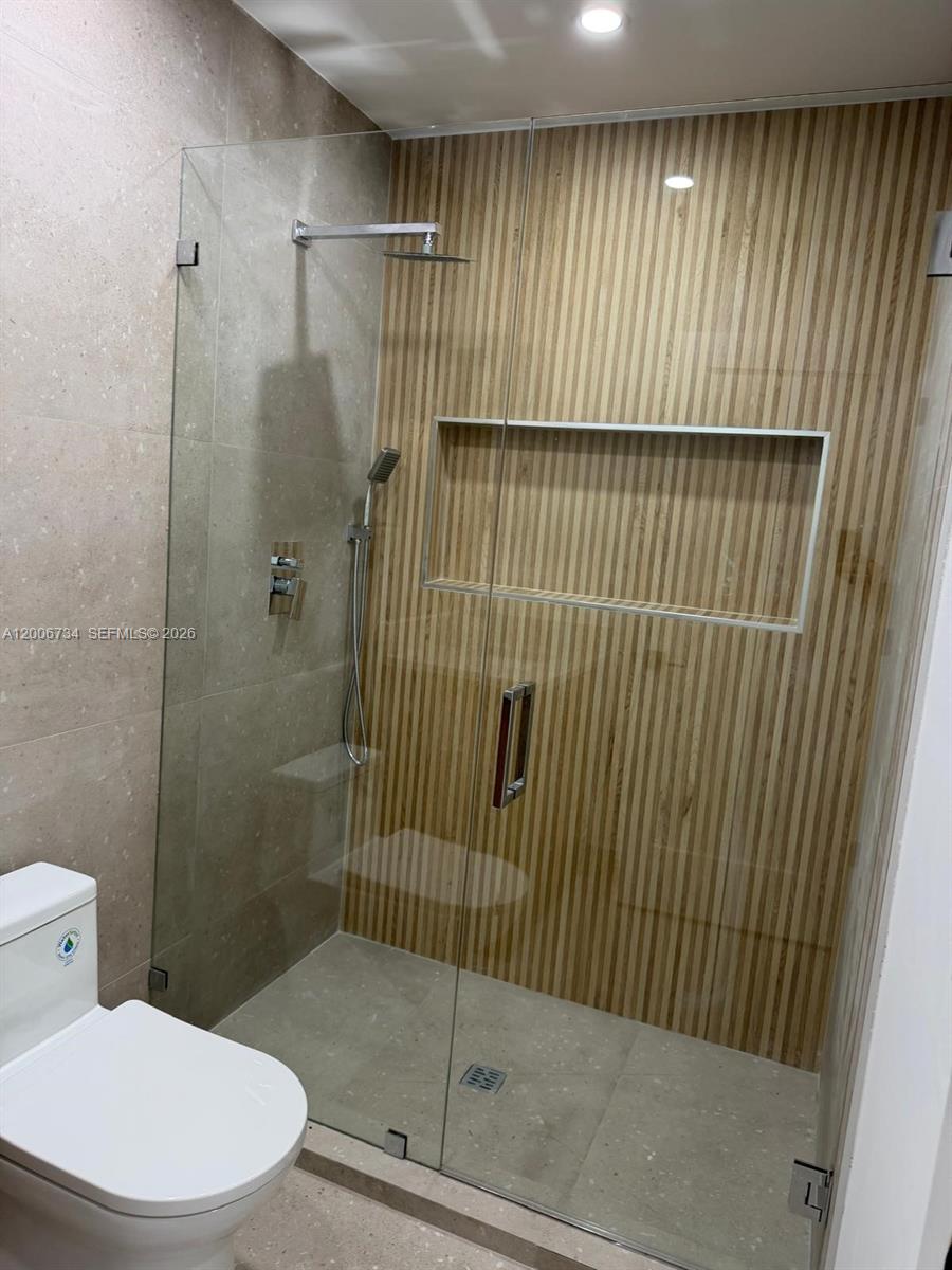 7917 Chula Vista Crescent Boca Raton, FL 33433 - Photo 26 of 28 a bathroom with a toilet and shower