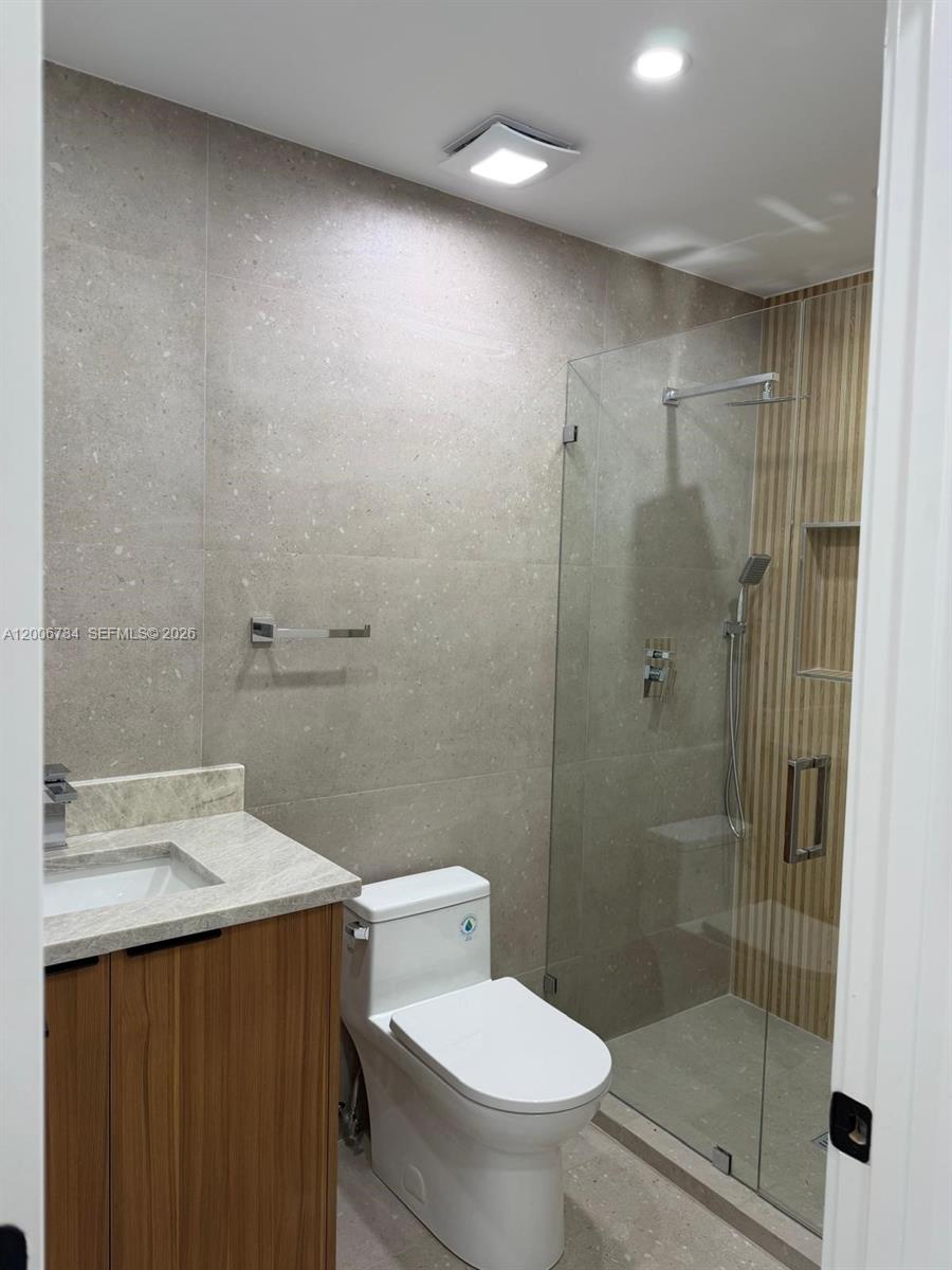 7917 Chula Vista Crescent Boca Raton, FL 33433 - Photo 27 of 28 a bathroom with a shower a toilet and sink