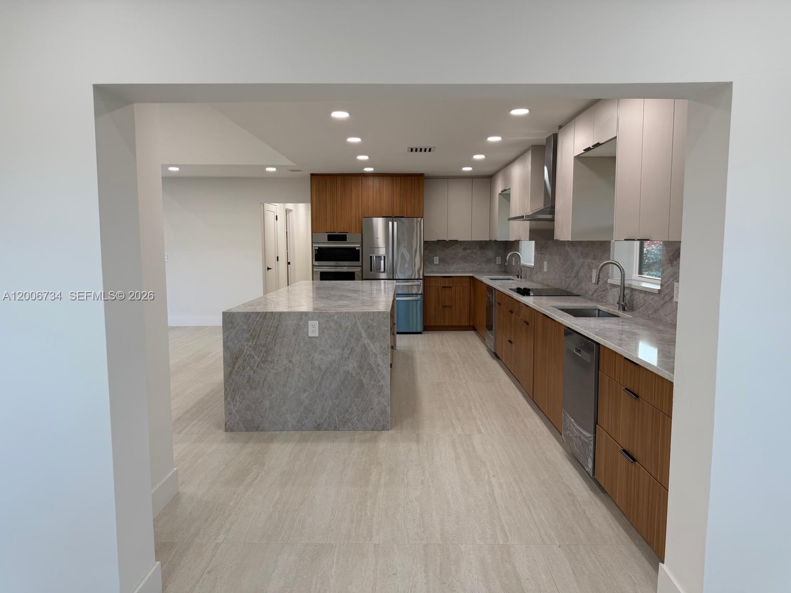 7917 Chula Vista Crescent Boca Raton, FL 33433 - Photo 5 of 28 a large kitchen with stainless steel appliances kitchen island a large counter top and a stove top oven