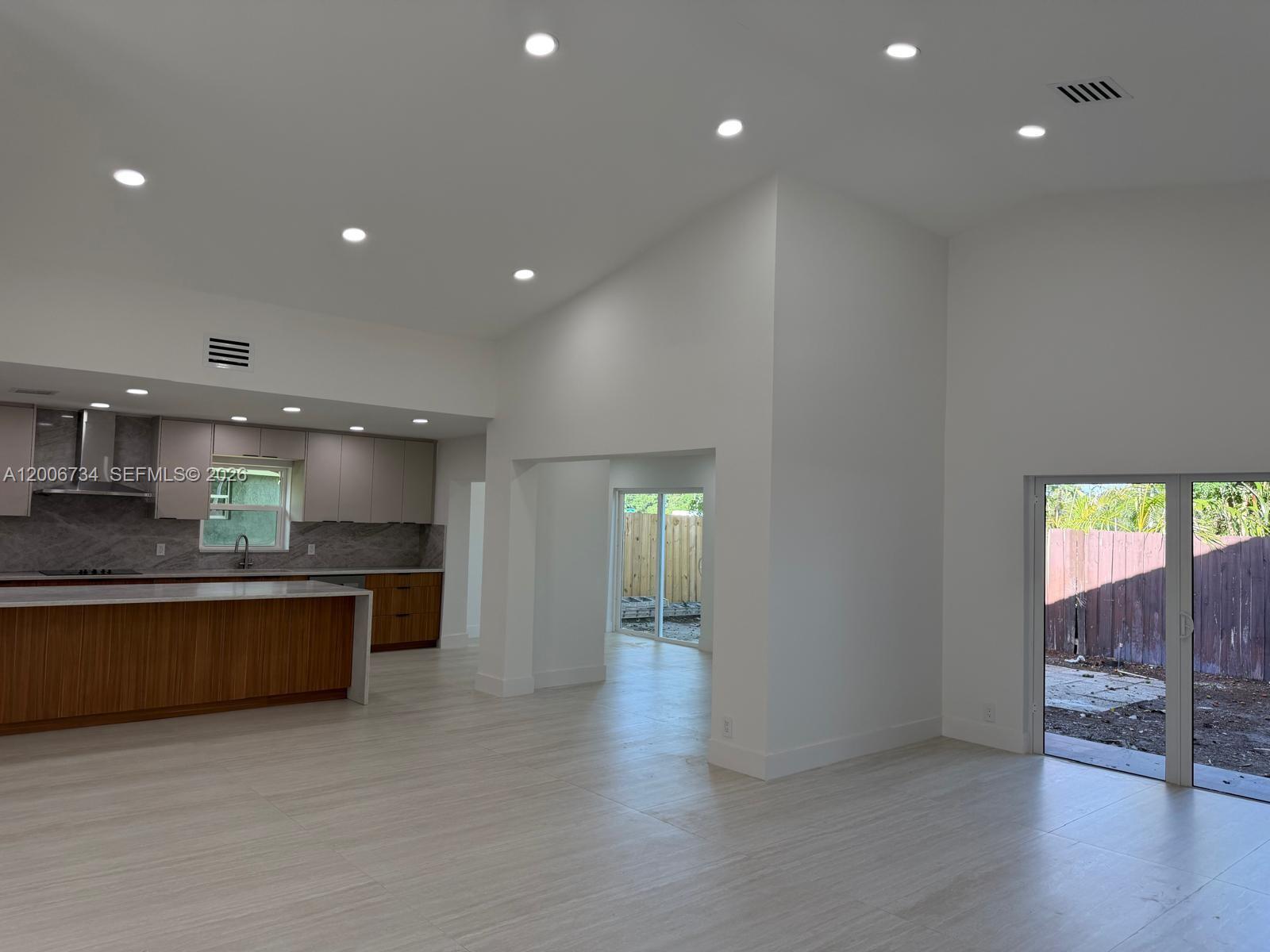 7917 Chula Vista Crescent Boca Raton, FL 33433 - Photo 6 of 28 a large hall with stainless steel appliances granite countertop a stove and a large window
