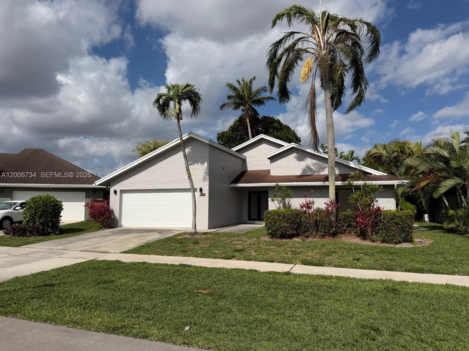 7917 Chula Vista Crescent Boca Raton, FL 33433 - Photo 10 of 28 a front view of a house with garden
