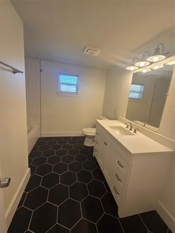 an empty room with closet and wooden floor