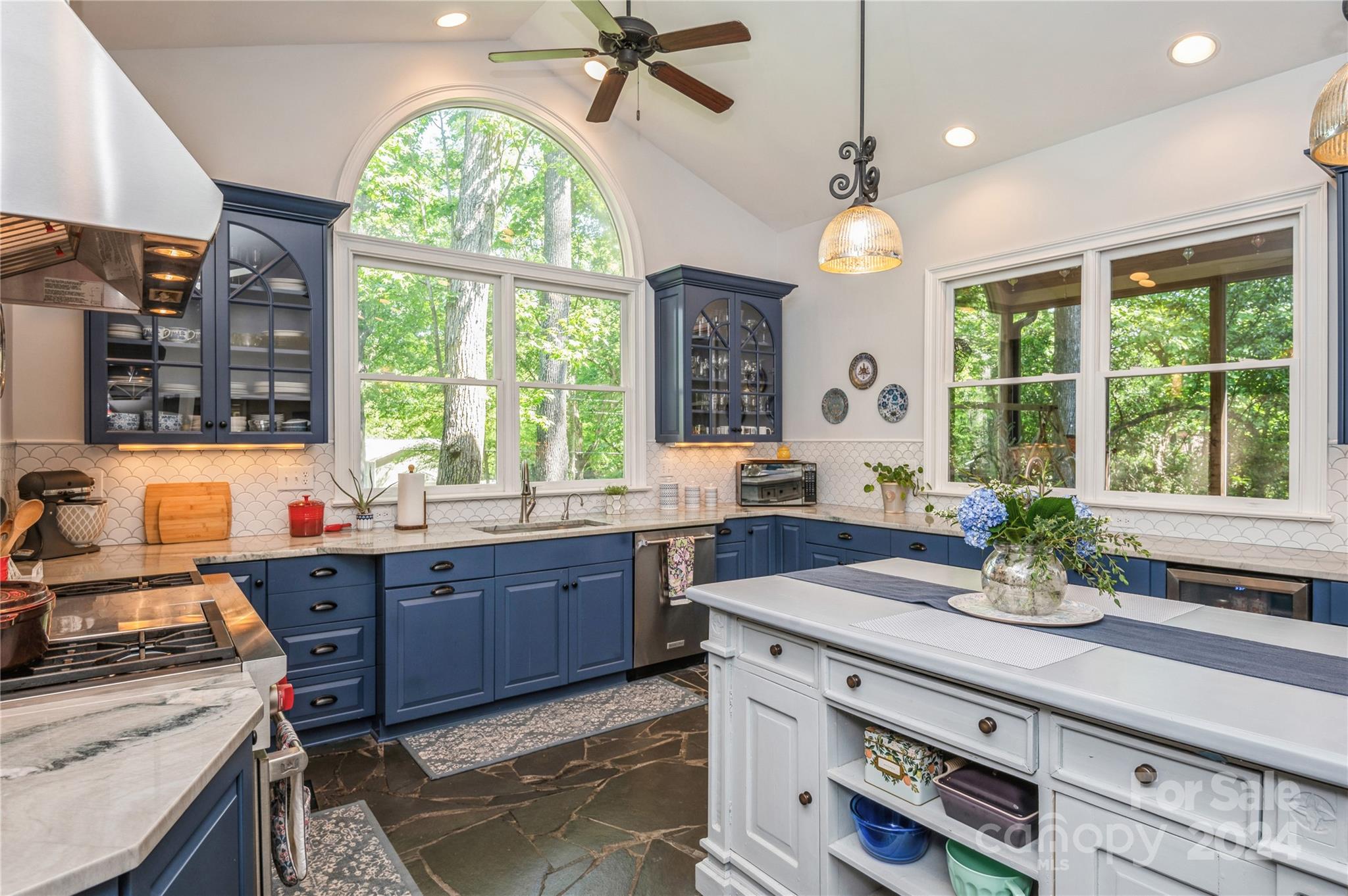 4027 Rutherford Drive Charlotte, NC 28210 - Photo 18 of 48 a kitchen with granite countertop a stove a sink and a window