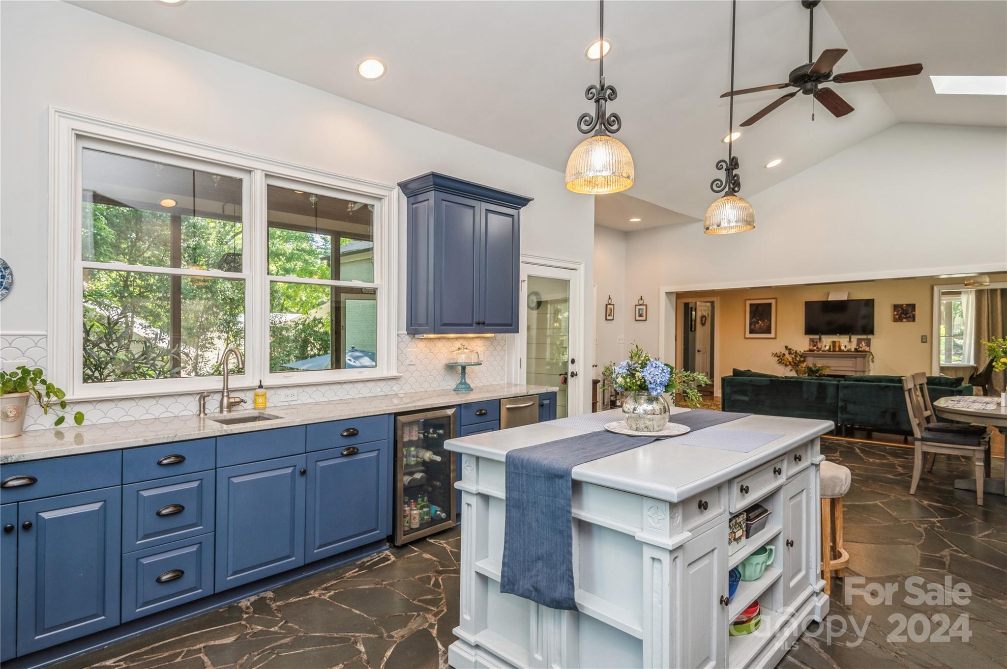 4027 Rutherford Drive Charlotte, NC 28210 - Photo 19 of 48 a kitchen with a stove a sink a center island and windows