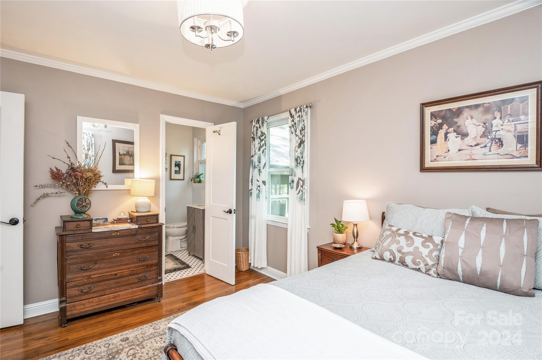 4027 Rutherford Drive Charlotte, NC 28210 - Photo 31 of 48 a bedroom with a bed and a chandelier