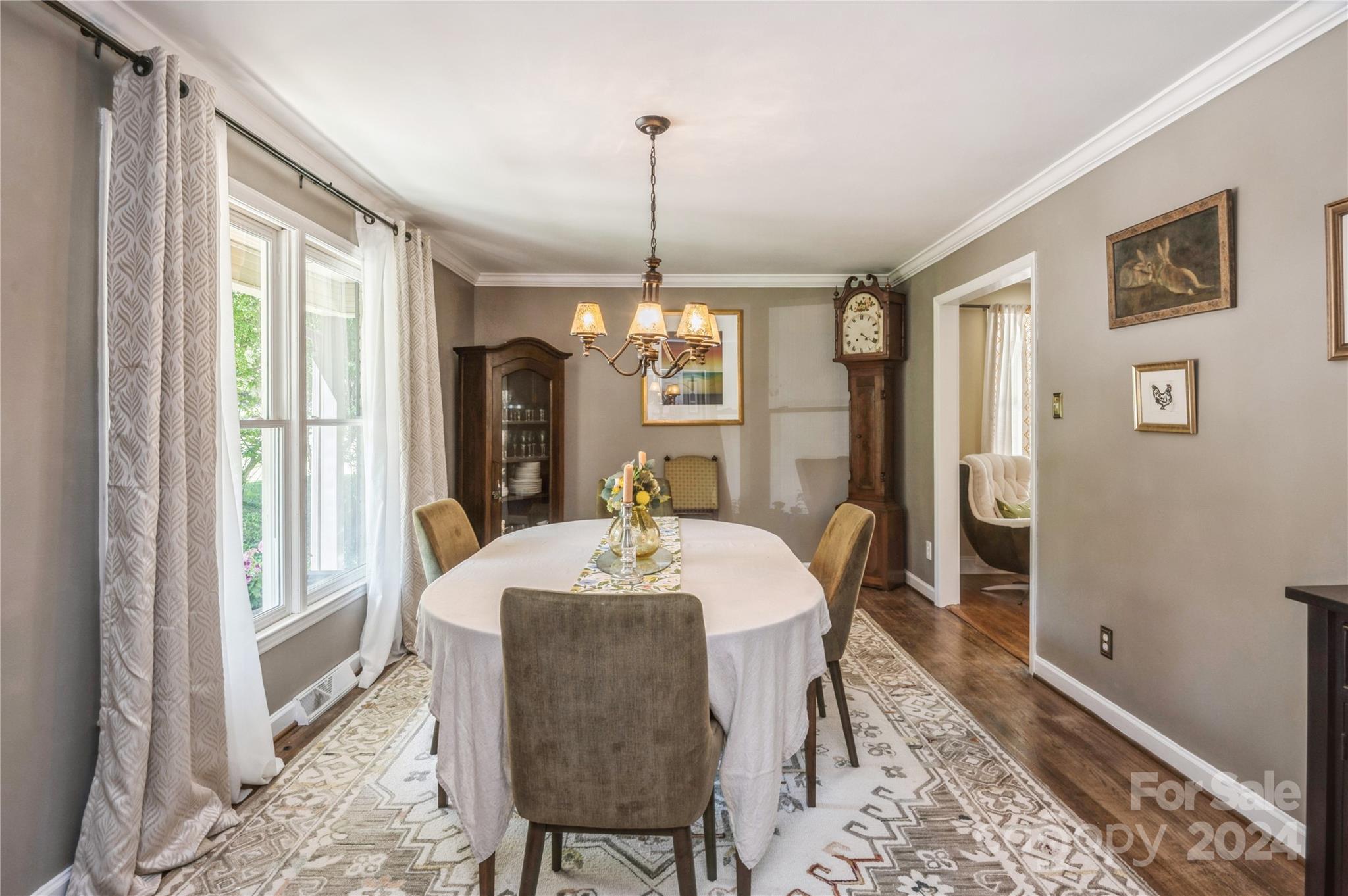 4027 Rutherford Drive Charlotte, NC 28210 - Photo 4 of 48 a dining room with furniture a chandelier and wooden floor
