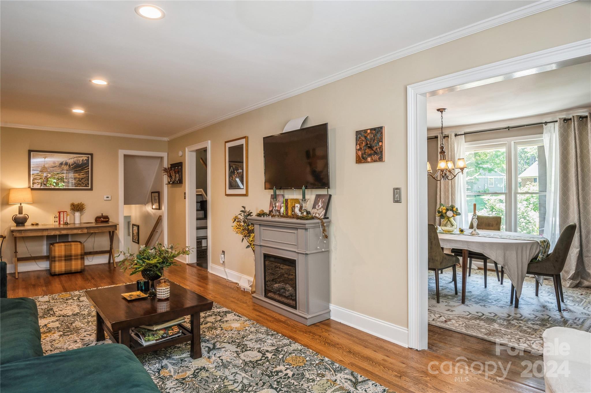 4027 Rutherford Drive Charlotte, NC 28210 - Photo 10 of 48 a living room with furniture a fireplace and a flat screen tv