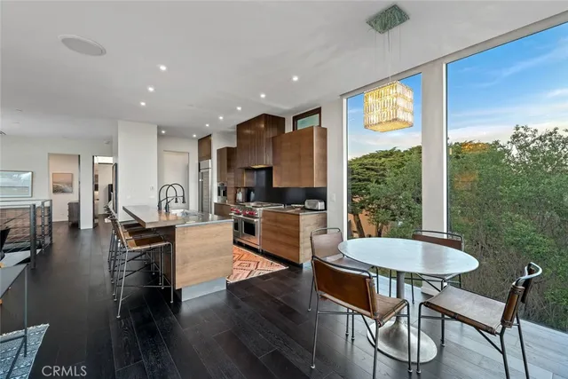 a kitchen with stainless steel appliances granite countertop a stove top oven a sink a counter space and cabinets