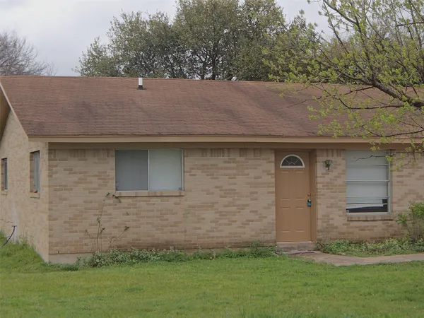 a brick house with a yard
