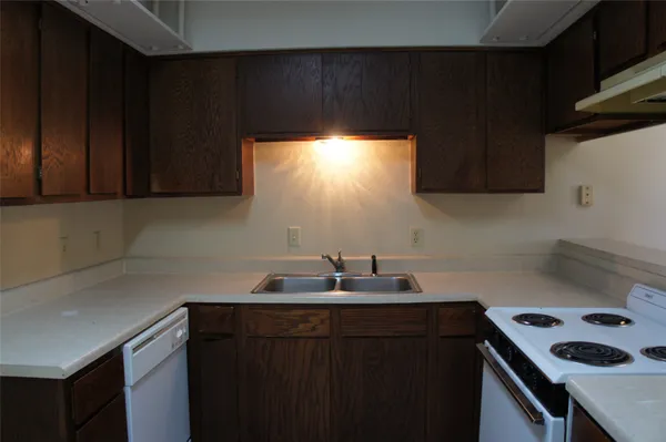a kitchen with a sink cabinets and a window