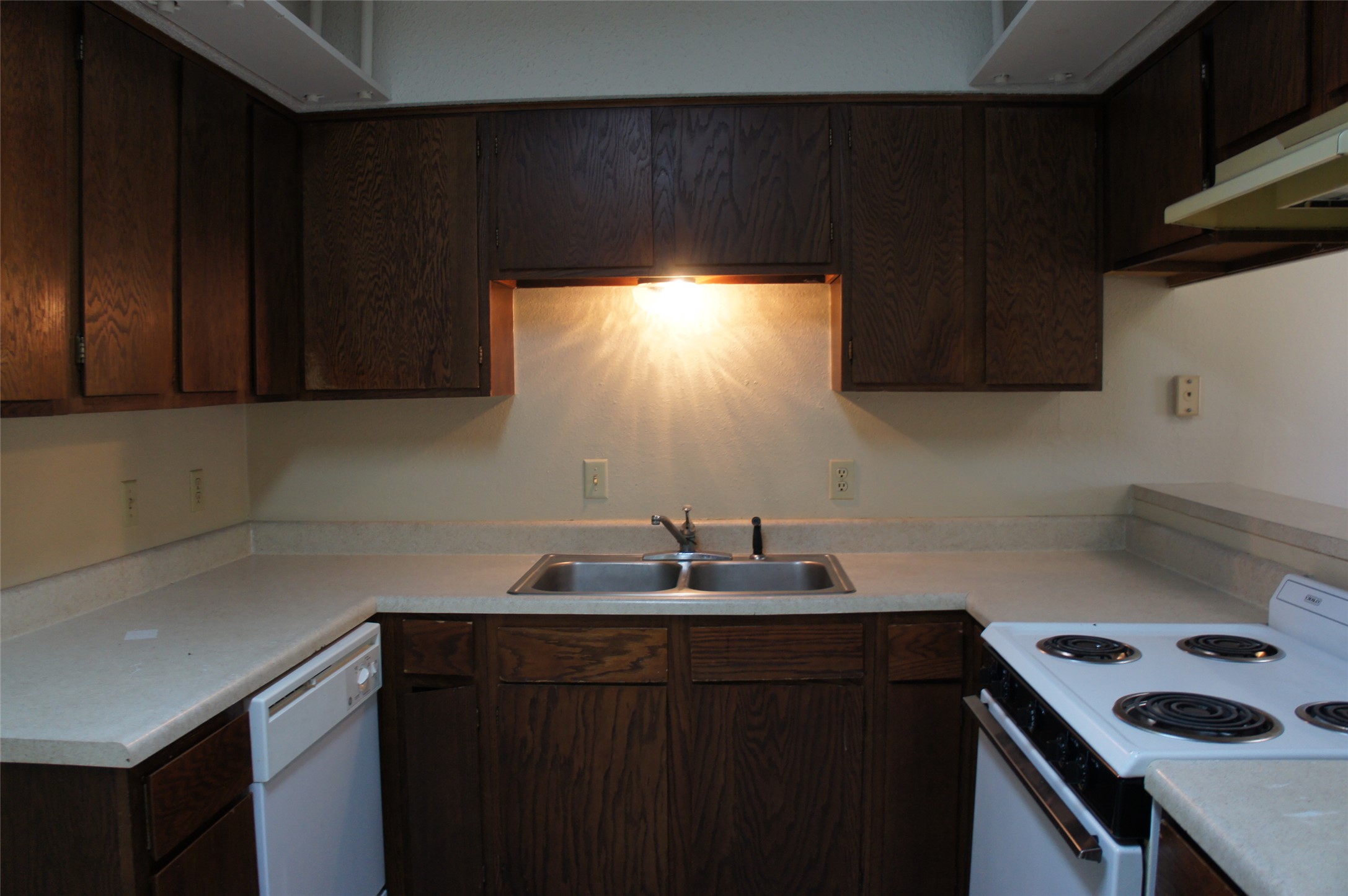 2500 Parker Drive, Unit A Georgetown, TX 78628 - Photo 5 of 9 Kitchen featuring dark wood finish cabinets, white appliances, and light countertops