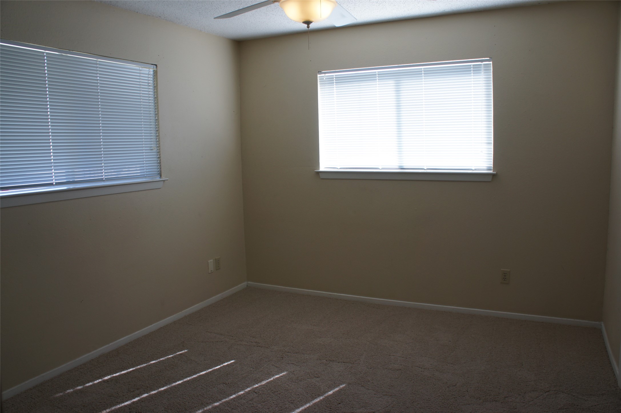 2500 Parker Drive, Unit A Georgetown, TX 78628 - Photo 6 of 9 Carpeted empty room with a ceiling fan and a textured ceiling