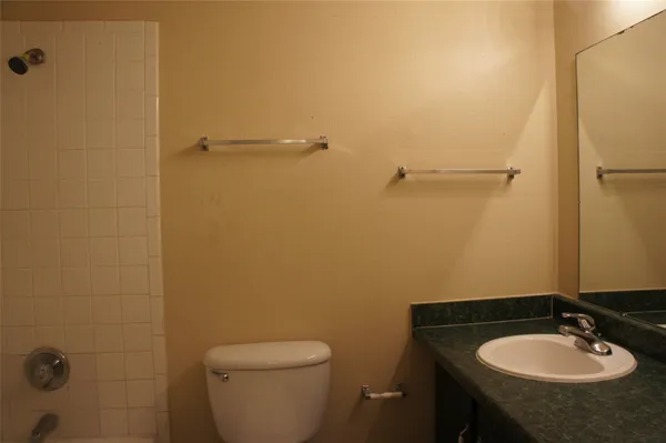 a bathroom with a sink toilet and a mirror