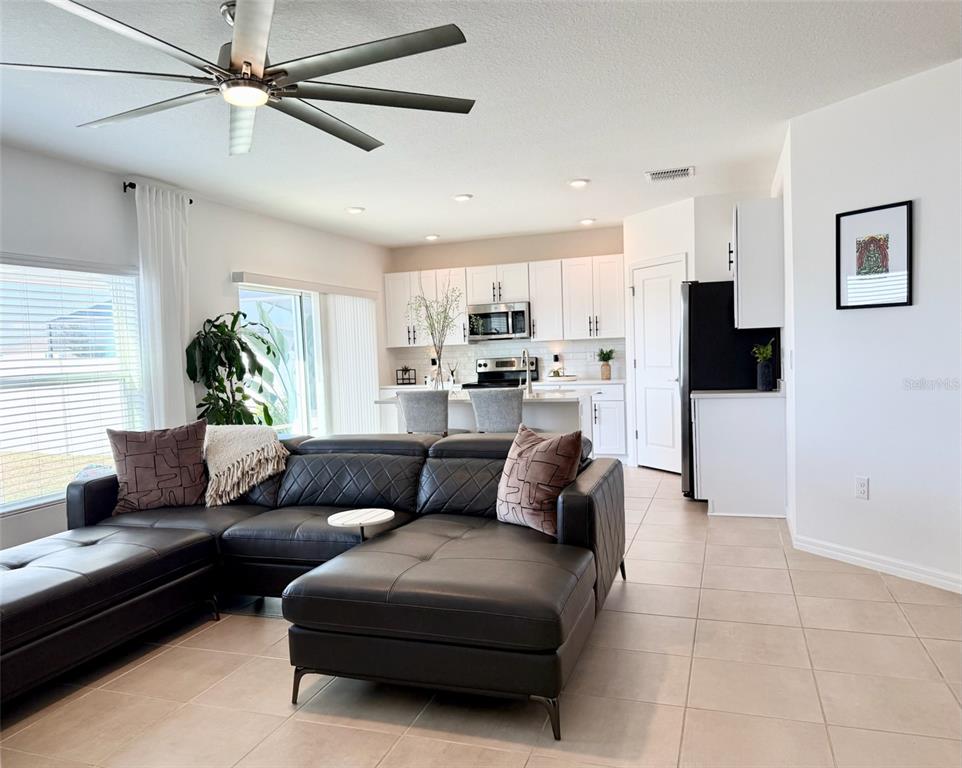 1126 Calico Pointe Circle Groveland, FL 34736 - Photo 11 of 28 a living room with furniture and a flat screen tv