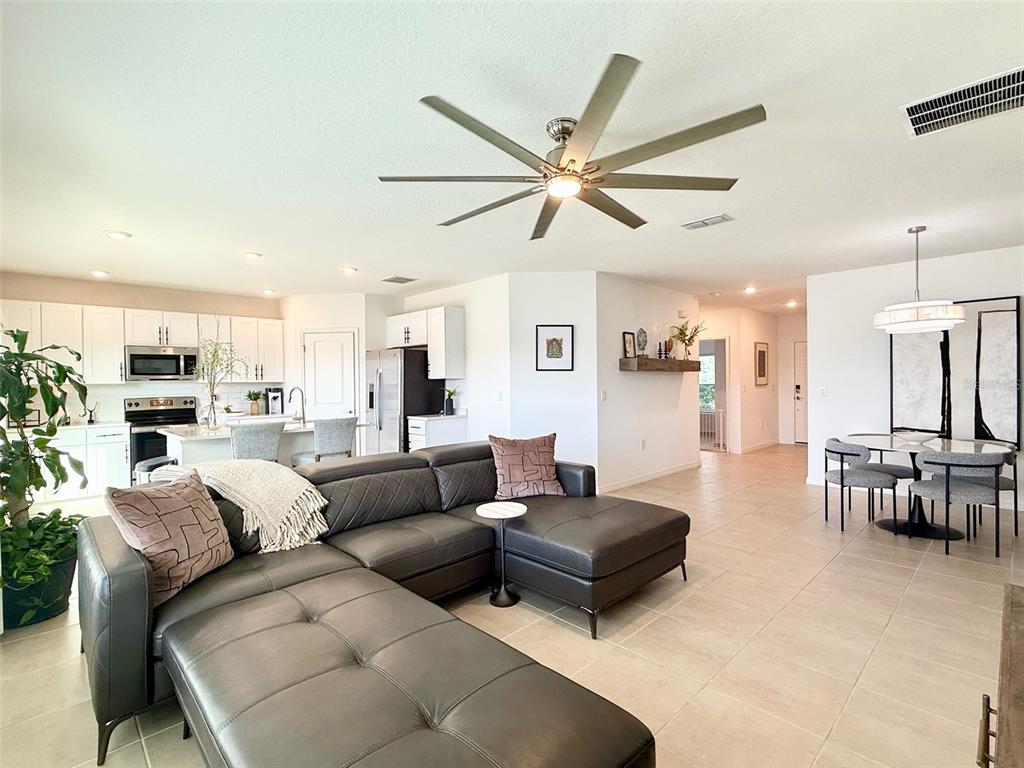1126 Calico Pointe Circle Groveland, FL 34736 - Photo 13 of 28 a living room with furniture and a large window
