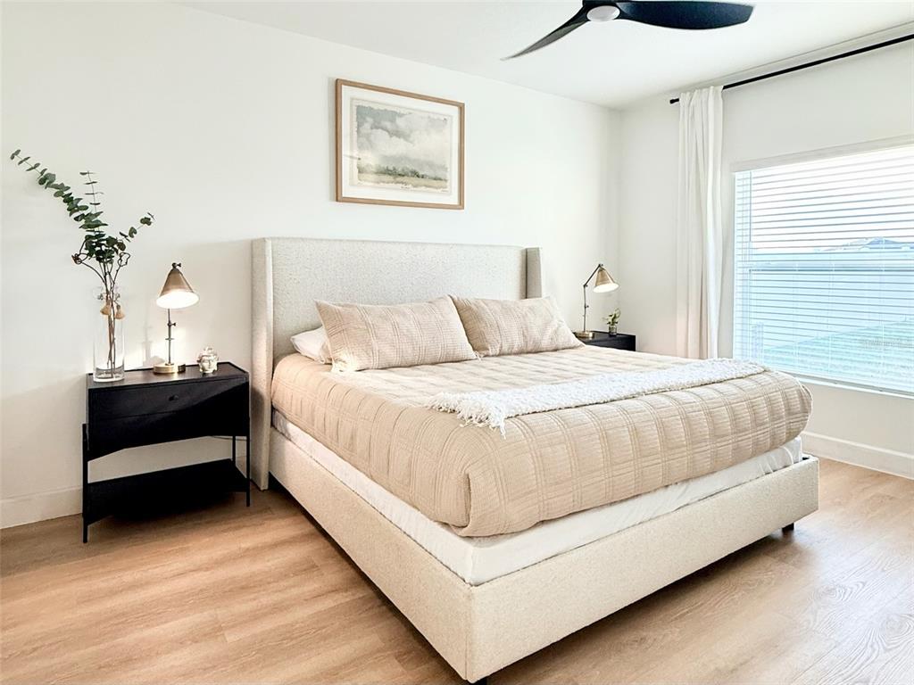 1126 Calico Pointe Circle Groveland, FL 34736 - Photo 15 of 28 a bedroom with bed and a night stand