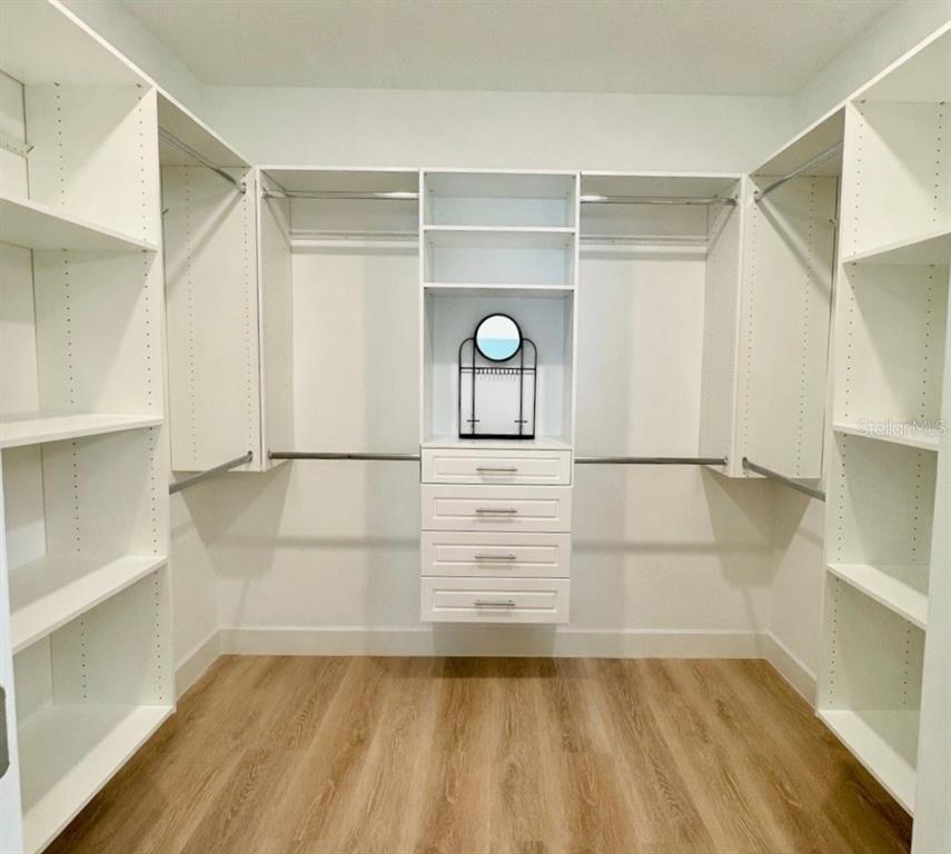 1126 Calico Pointe Circle Groveland, FL 34736 - Photo 18 of 28 a view of walk in closet with empty racks