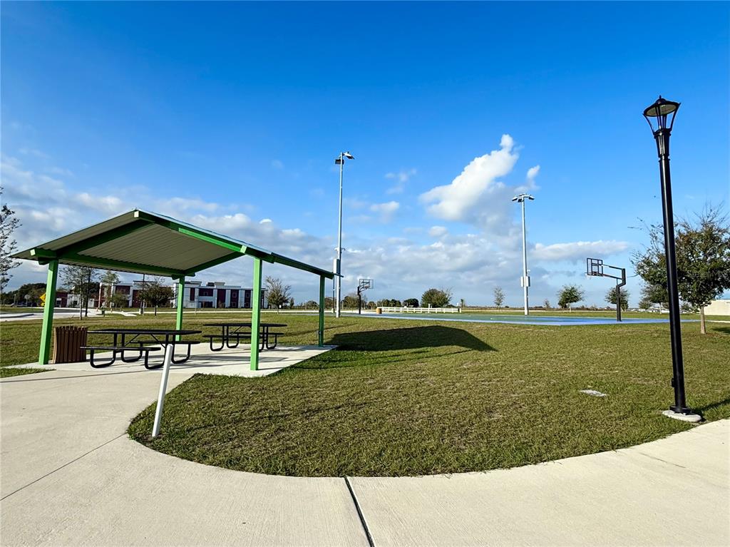 1126 Calico Pointe Circle Groveland, FL 34736 - Photo 28 of 28 a view of a swimming pool with a bench