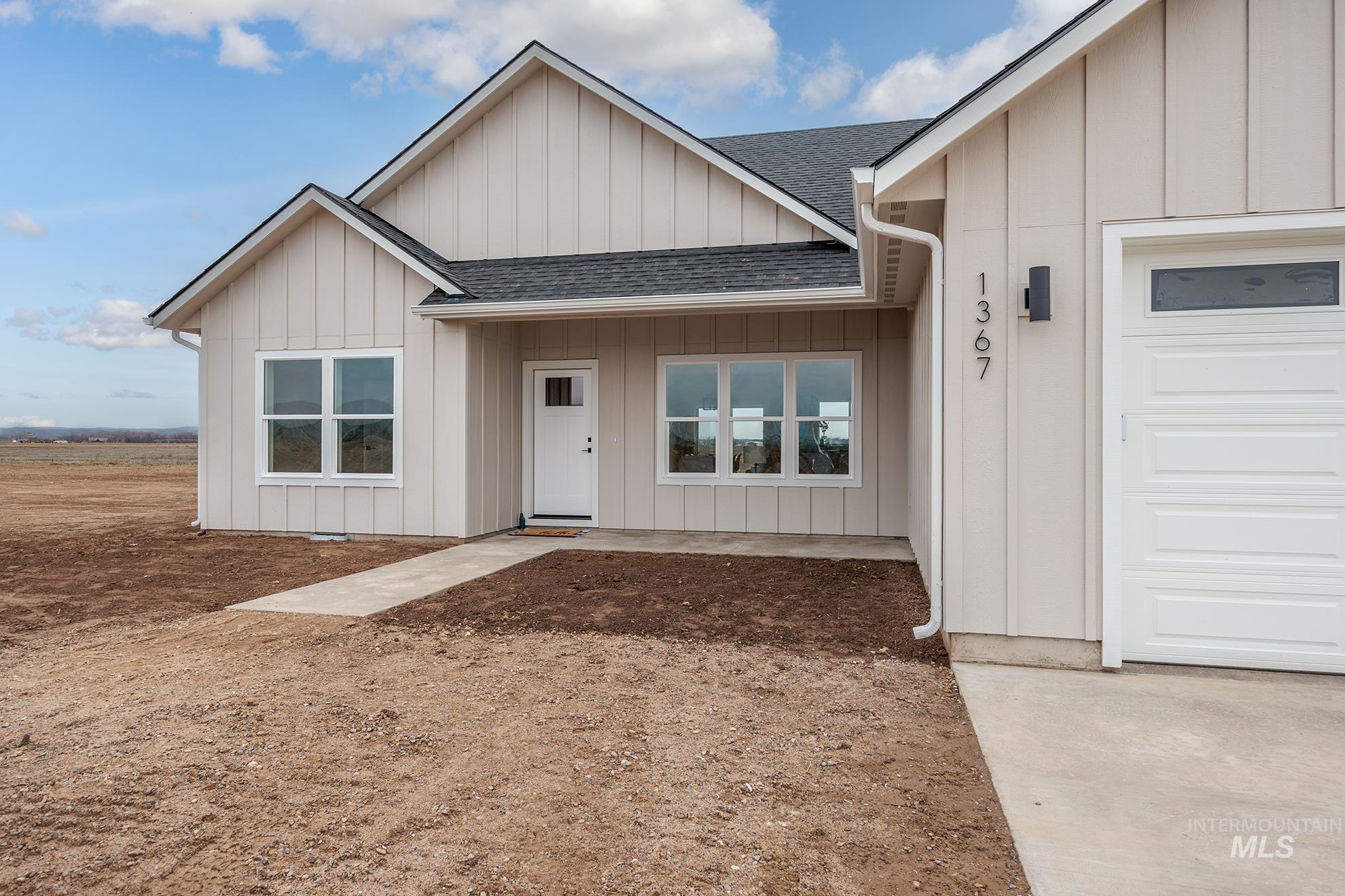 1367 Hansen Road Weiser, ID 83672 - Photo 1 of 36 View of front of house with roof with shingles, board and batten siding, and a garage