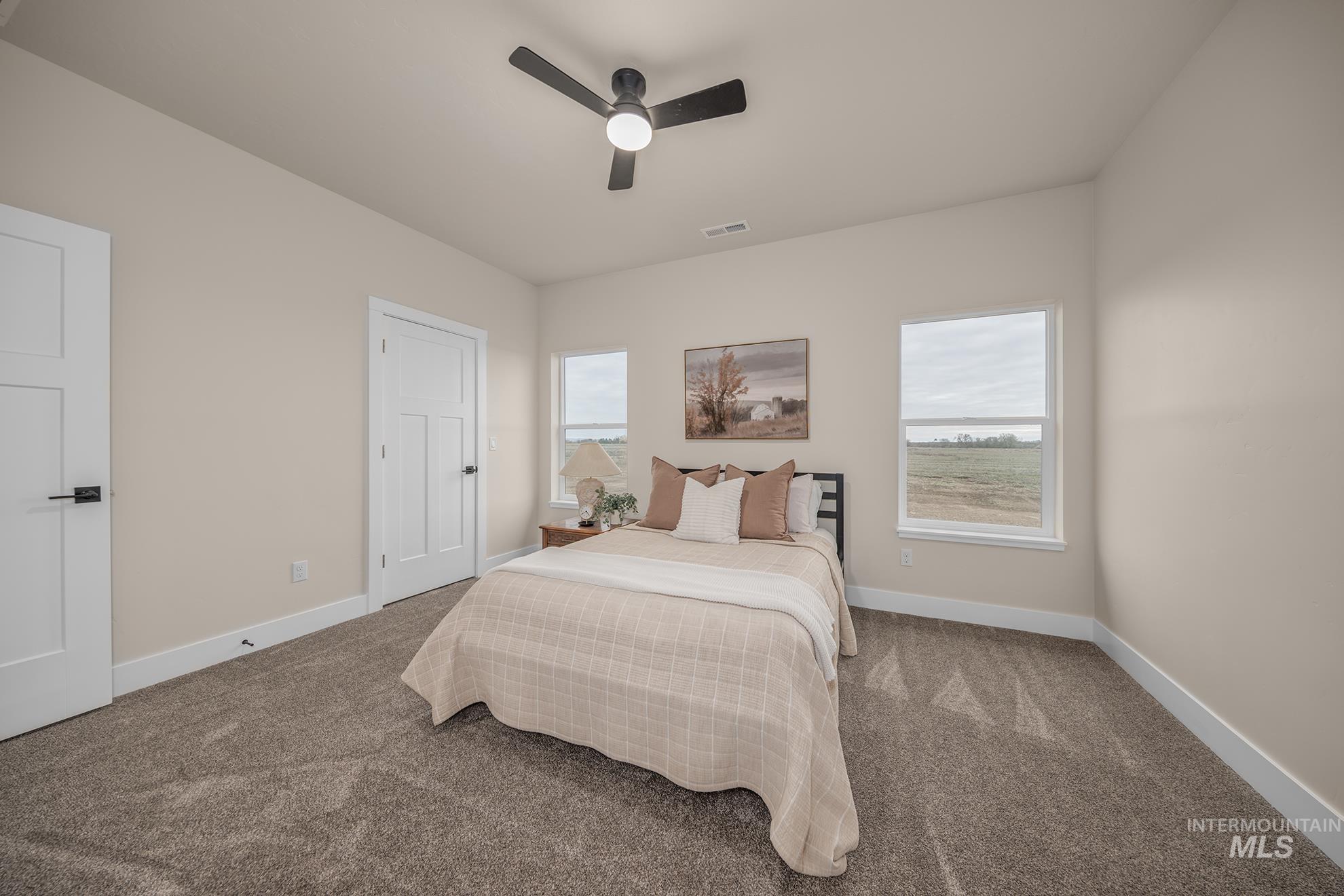 1367 Hansen Road Weiser, ID 83672 - Photo 13 of 36 Bedroom featuring carpet and a ceiling fan