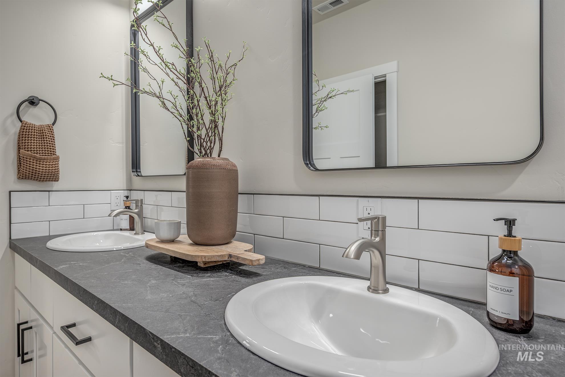 1367 Hansen Road Weiser, ID 83672 - Photo 15 of 36 Bathroom featuring double vanity and backsplash