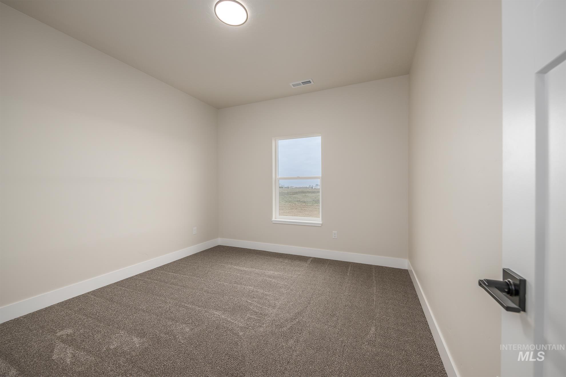 1367 Hansen Road Weiser, ID 83672 - Photo 17 of 36 Carpeted spare room featuring baseboards