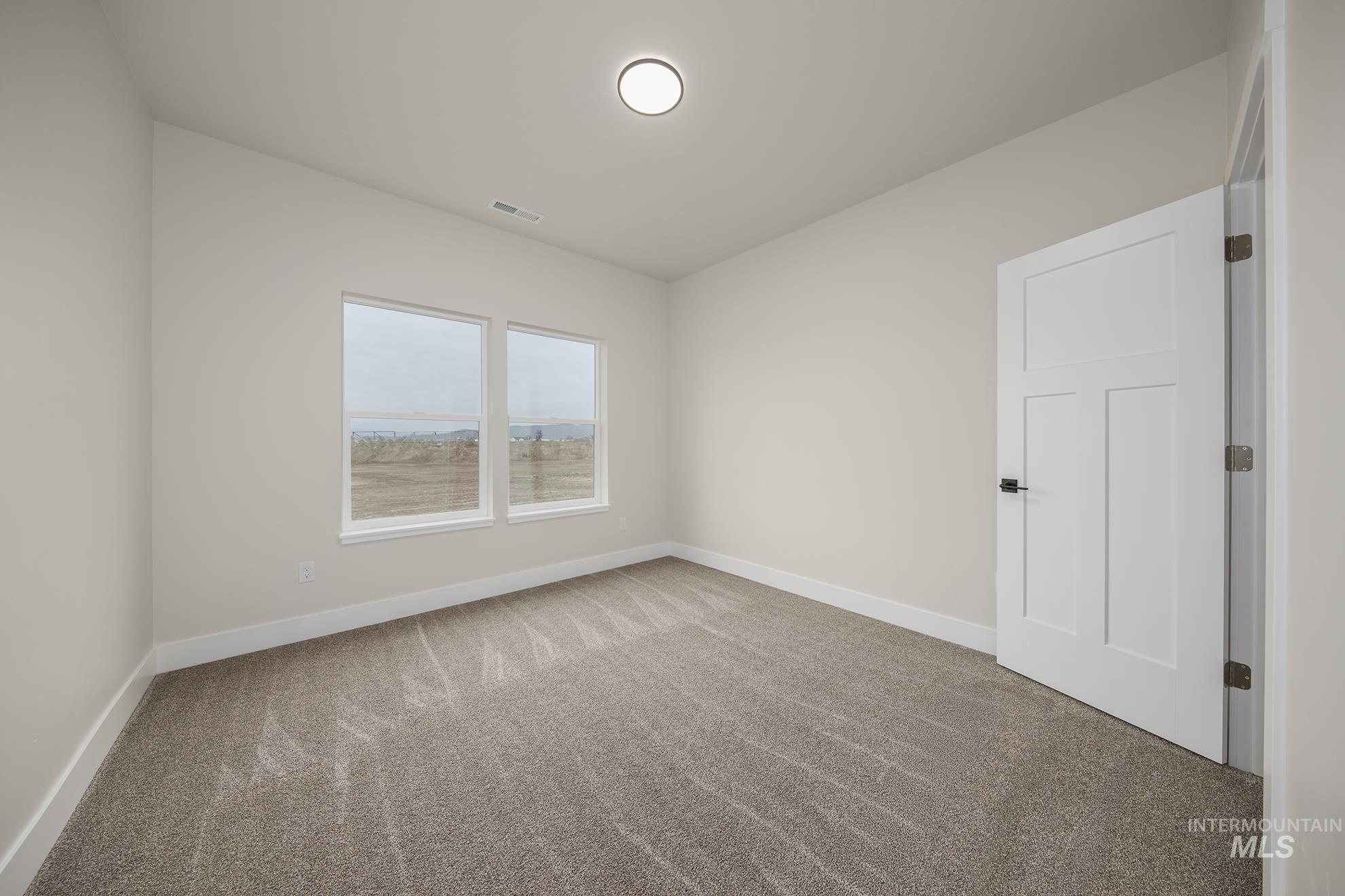 1367 Hansen Road Weiser, ID 83672 - Photo 20 of 36 Unfurnished room with baseboards and light carpet